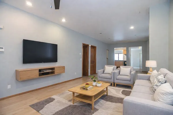 a living room with furniture and a flat screen tv
