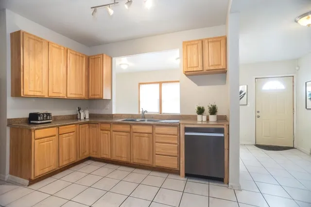 a kitchen with a sink window and cabinets