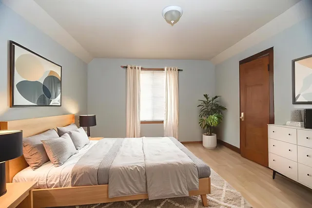 a bedroom with a bed and a dresser