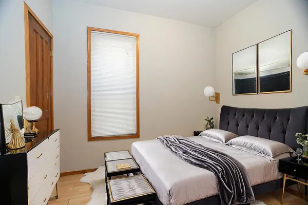 a bedroom with a bed and a window