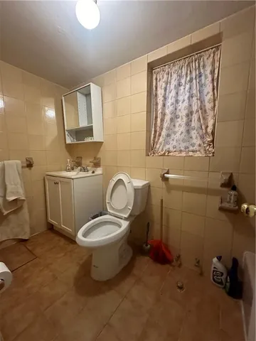 a bathroom with a sink toilet and a mirror
