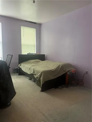 a bedroom with a bed and window