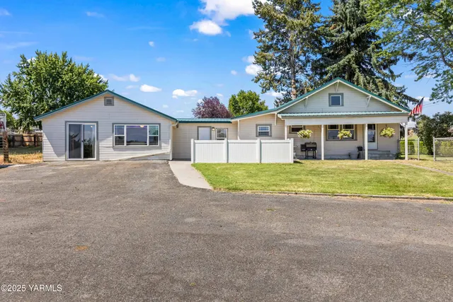 a front view of house with yard and green space