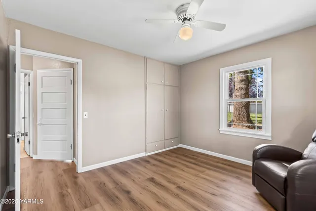 a view of a workspace with furniture and a flat screen tv