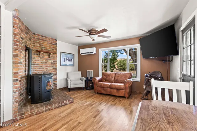 a living room with fireplace furniture and a flat screen tv