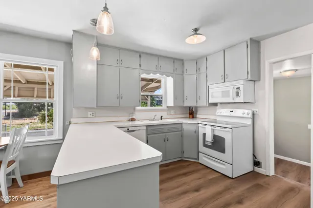 a kitchen that has a sink and a stove in it