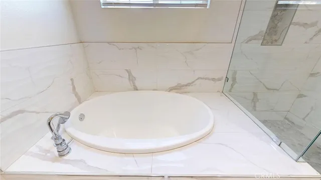 a bathroom with a glass shower door