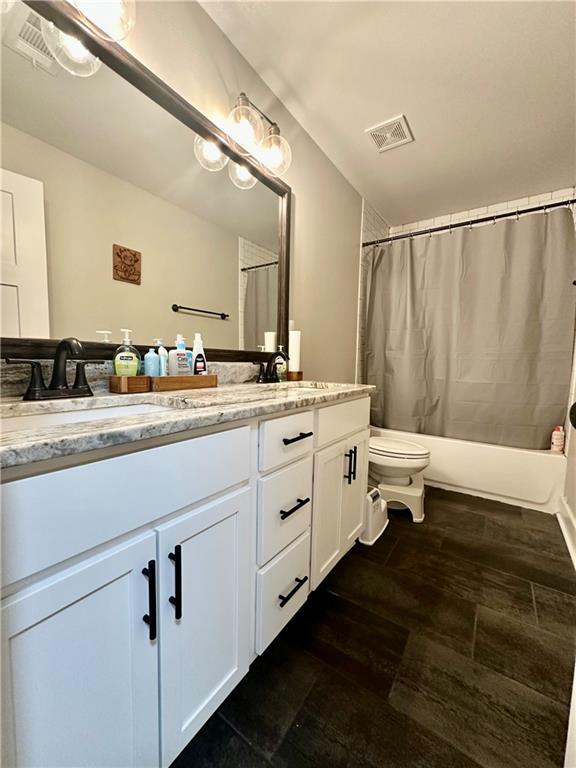 815 Poplar Street Monticello, GA 31064 - Photo 29 of 33 a spacious bathroom with a double vanity sink and mirror