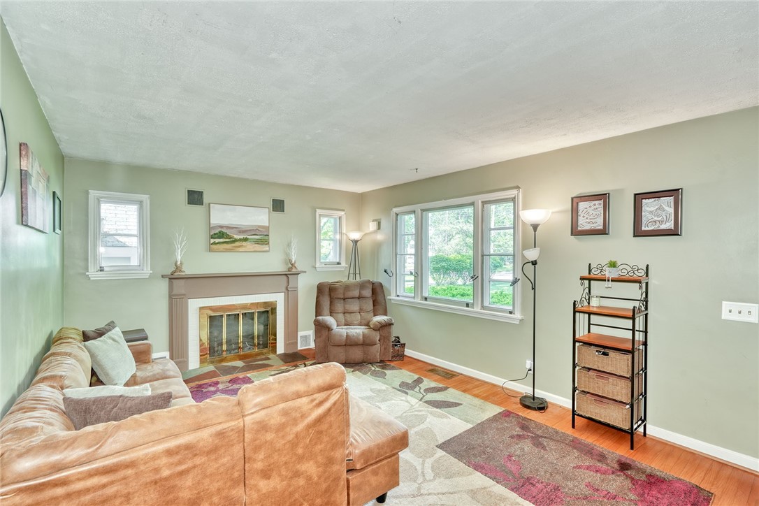 606 Bay Road Webster, NY 14580 - Photo 6 of 49 Family room with hardwood floors, wood-burning fir