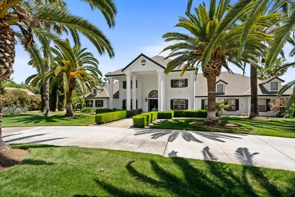 a living room with furniture piano and a window