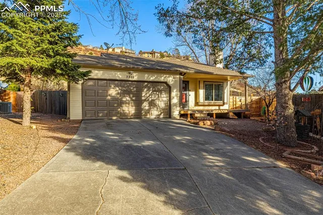 a view of a house with a large tree