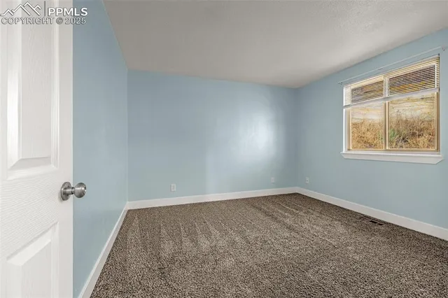 a view of empty room with windows