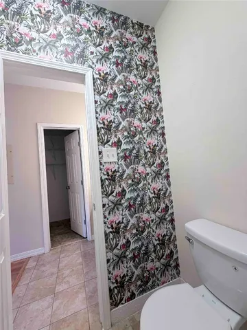 a bathroom with a toilet and a shower curtain