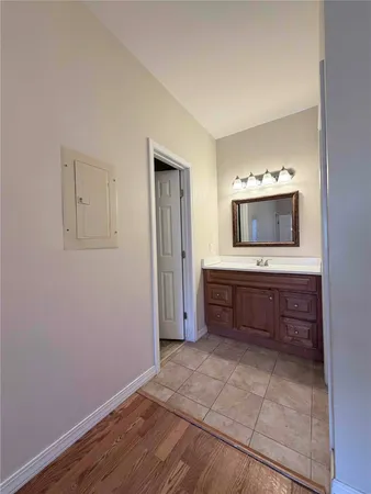 an empty room with a bathroom and a sink