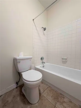 a bathroom with a toilet and a bathtub