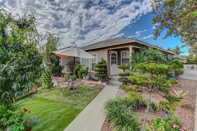 a front view of a house with a yard table and chairs