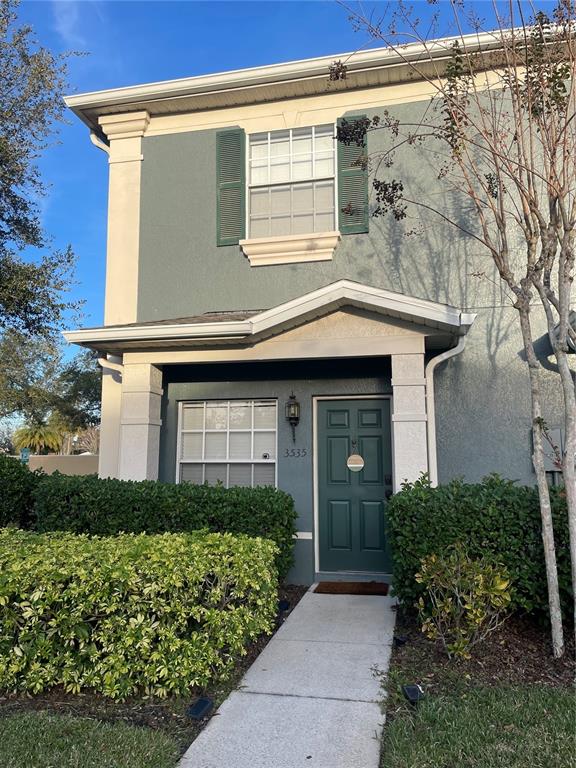 3535 Wilshire Way Road, Unit 52 Orlando, FL 32829 - Photo 1 of 1 a front view of a house with a garden