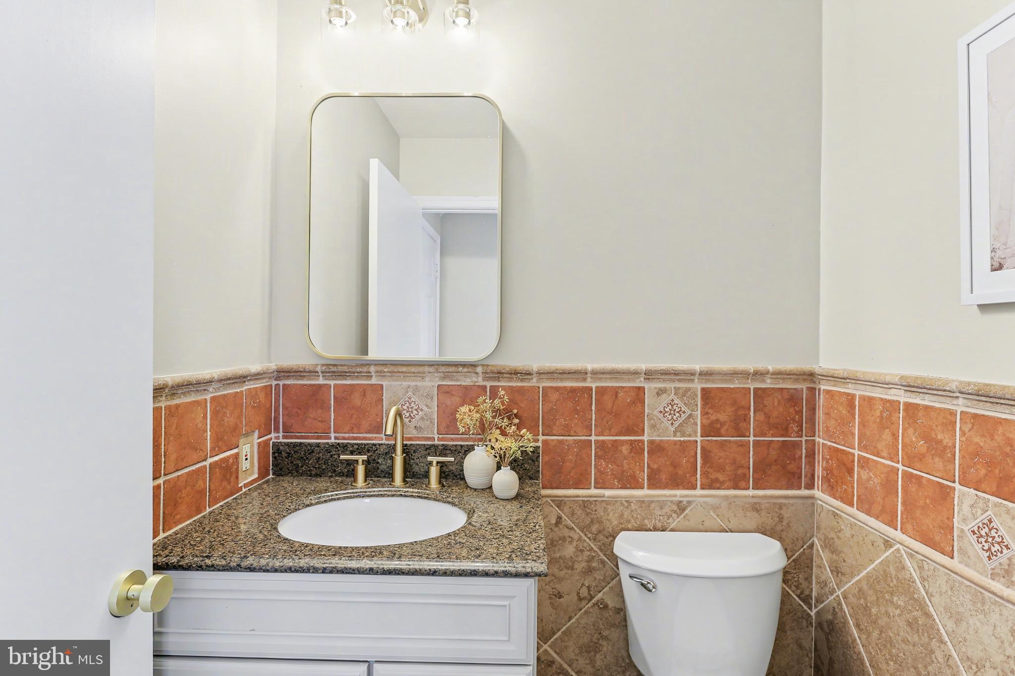 175 Timber Lane Lebanon, PA 17042 - Photo 20 of 39 a bathroom with a granite countertop sink a toilet a mirror and a window