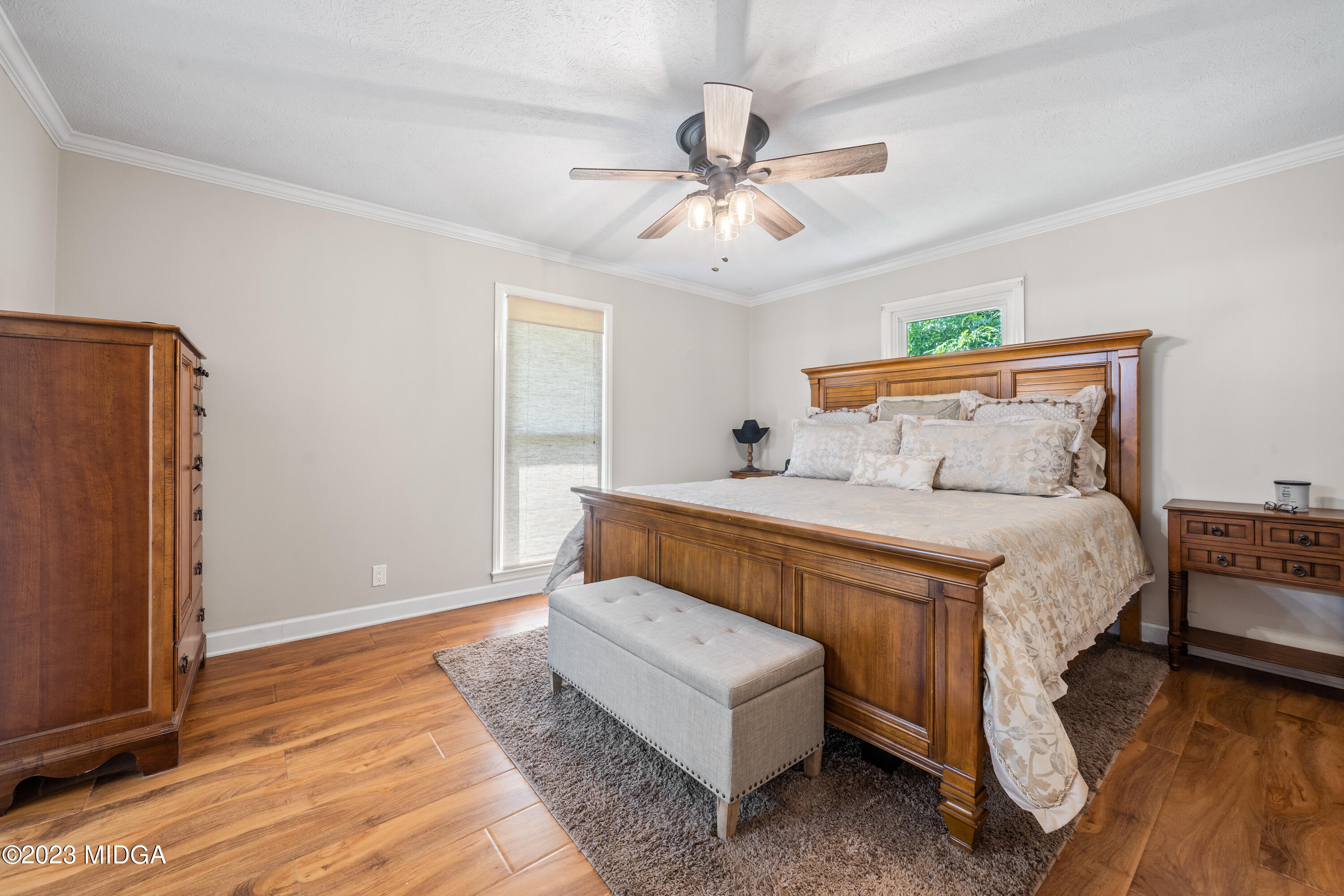 421 Plantation Road Gray, GA 31032 - Photo 14 of 31 a bedroom with a bed and a chandelier