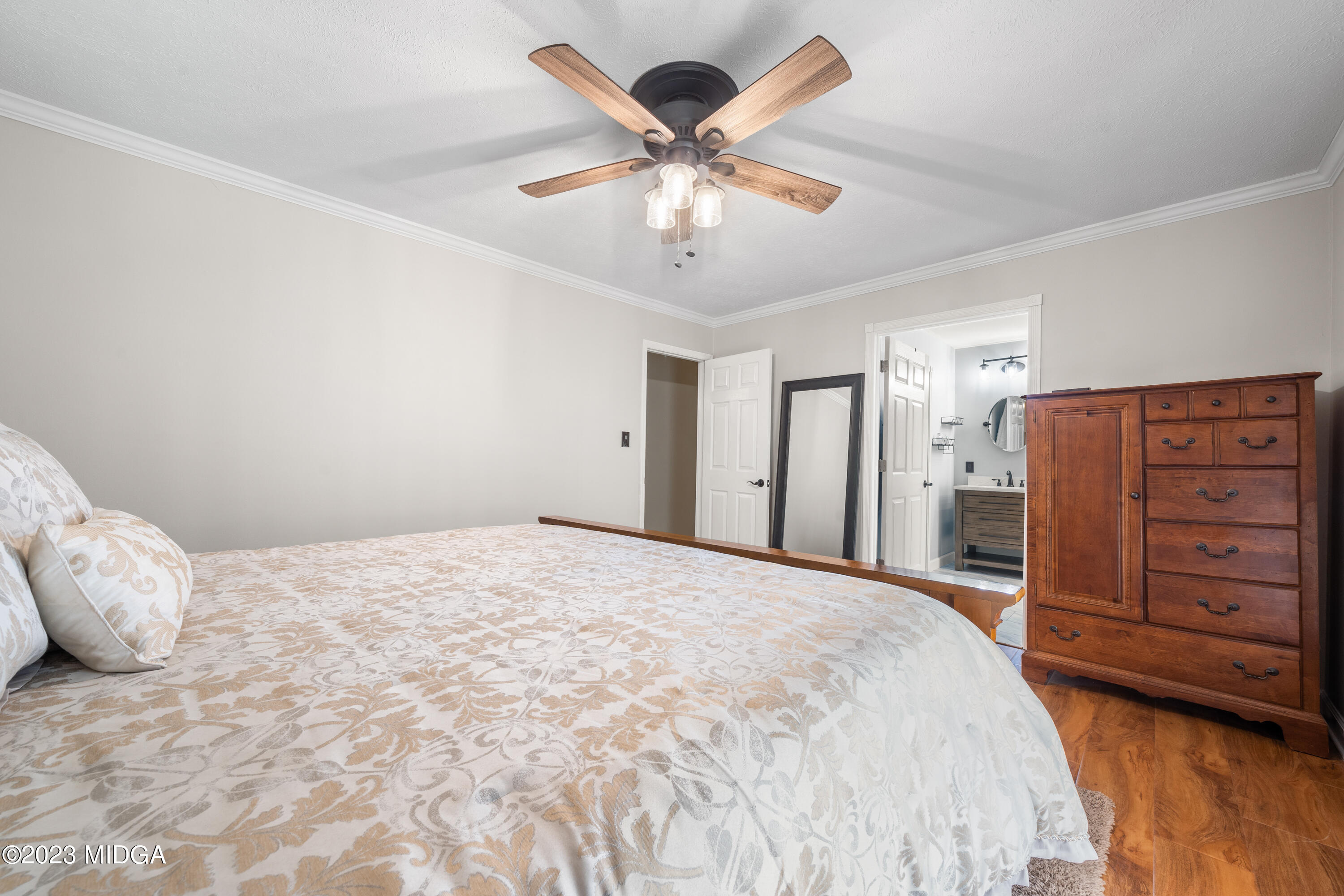 421 Plantation Road Gray, GA 31032 - Photo 15 of 31 a bedroom with a bed and a ceiling fan