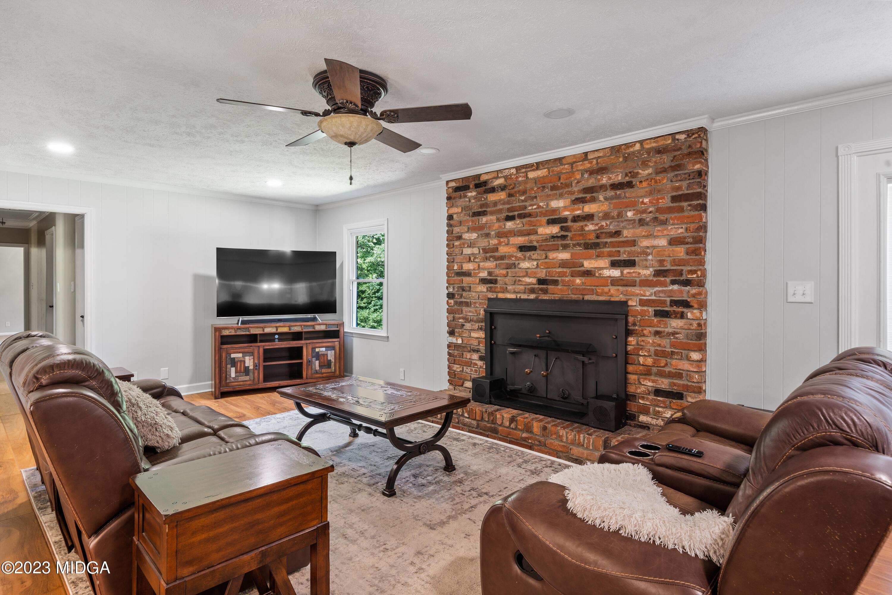 421 Plantation Road Gray, GA 31032 - Photo 8 of 31 a living room with furniture a flat screen tv and a fireplace