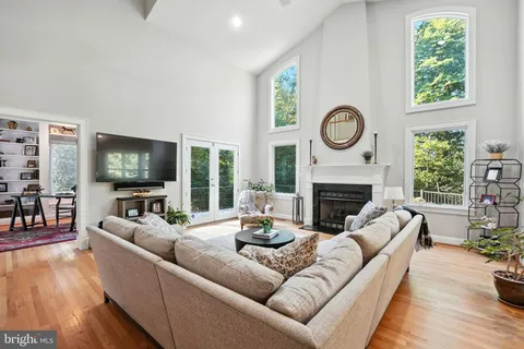 a living room with furniture a fireplace and a large window