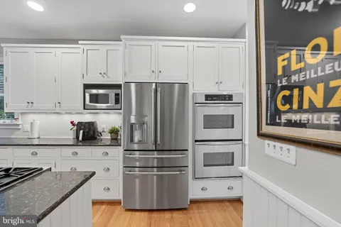 a kitchen with sink stove and cabinets