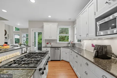 a spacious bedroom with a bed and a chandelier