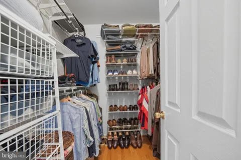 a bedroom with a bed dresser and a window