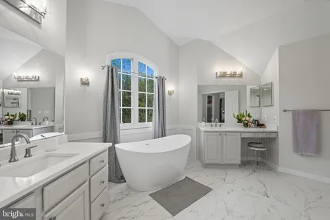 a view of a workspace with furniture and a chandelier fan