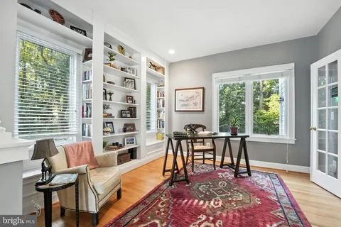 a view of a dining room with furniture wooden floor and chandelier
