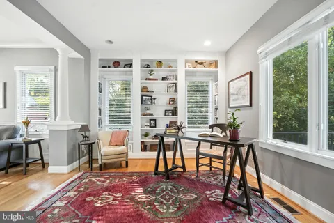 a living room with furniture a large window and a fireplace