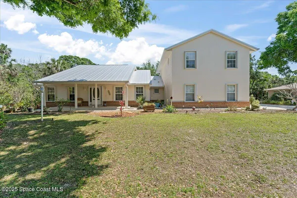 an aerial view of a house with garden space and street view