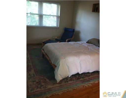 199 Evergreen Road, Unit 13B Edison, NJ 08837 - Photo 11 of 16 a bed sitting in a bedroom next to a window