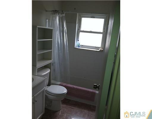 199 Evergreen Road, Unit 13B Edison, NJ 08837 - Photo 12 of 16 a bathroom with a toilet a sink and a window