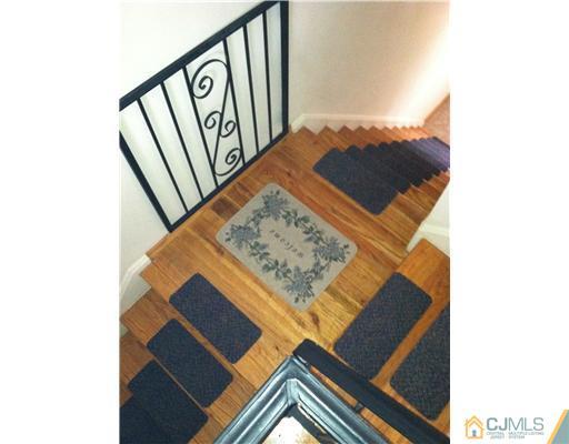 199 Evergreen Road, Unit 13B Edison, NJ 08837 - Photo 4 of 16 a view of staircase with a rug