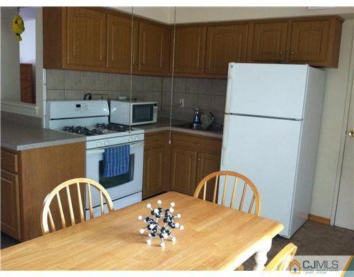 199 Evergreen Road, Unit 13B Edison, NJ 08837 - Photo 5 of 16 a view of a dining table and chairs