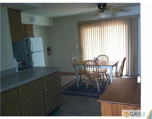 199 Evergreen Road, Unit 13B Edison, NJ 08837 - Photo 6 of 16 a dining room with furniture and window