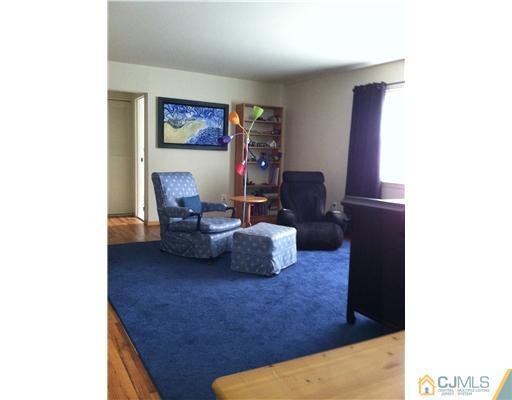199 Evergreen Road, Unit 13B Edison, NJ 08837 - Photo 8 of 16 a living room with furniture and a window