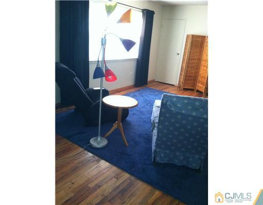 199 Evergreen Road, Unit 13B Edison, NJ 08837 - Photo 9 of 16 a view of a room with wooden floor and furniture