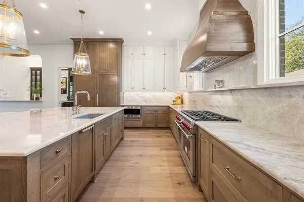 a large kitchen with stainless steel appliances granite countertop a sink and a stove
