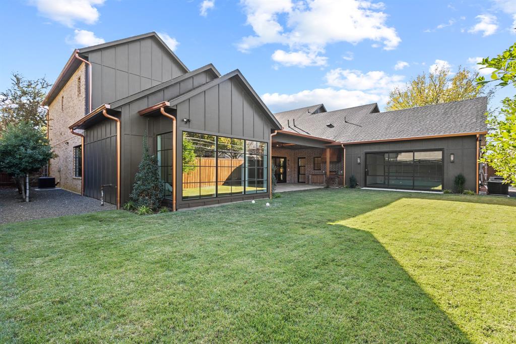 5925 Williamstown Road Dallas, TX 75230 - Photo 28 of 29 Back of house featuring a patio, a lawn, board and batten siding, and roof with shingles