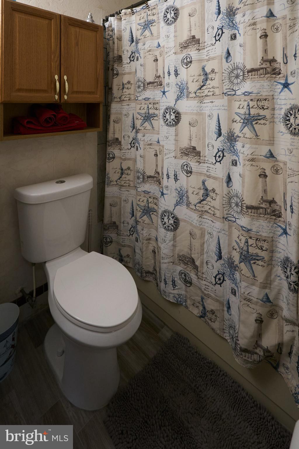 2113 Pennsylvania Avenue Croydon, PA 19021 - Photo 17 of 36 a white toilet sitting next to a shower curtain
