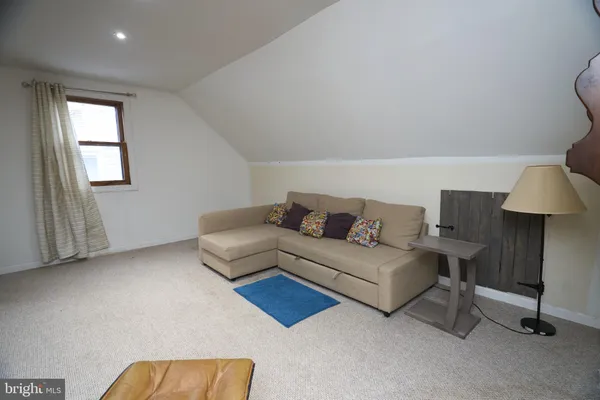 a bedroom with a bed and a flat tv screen