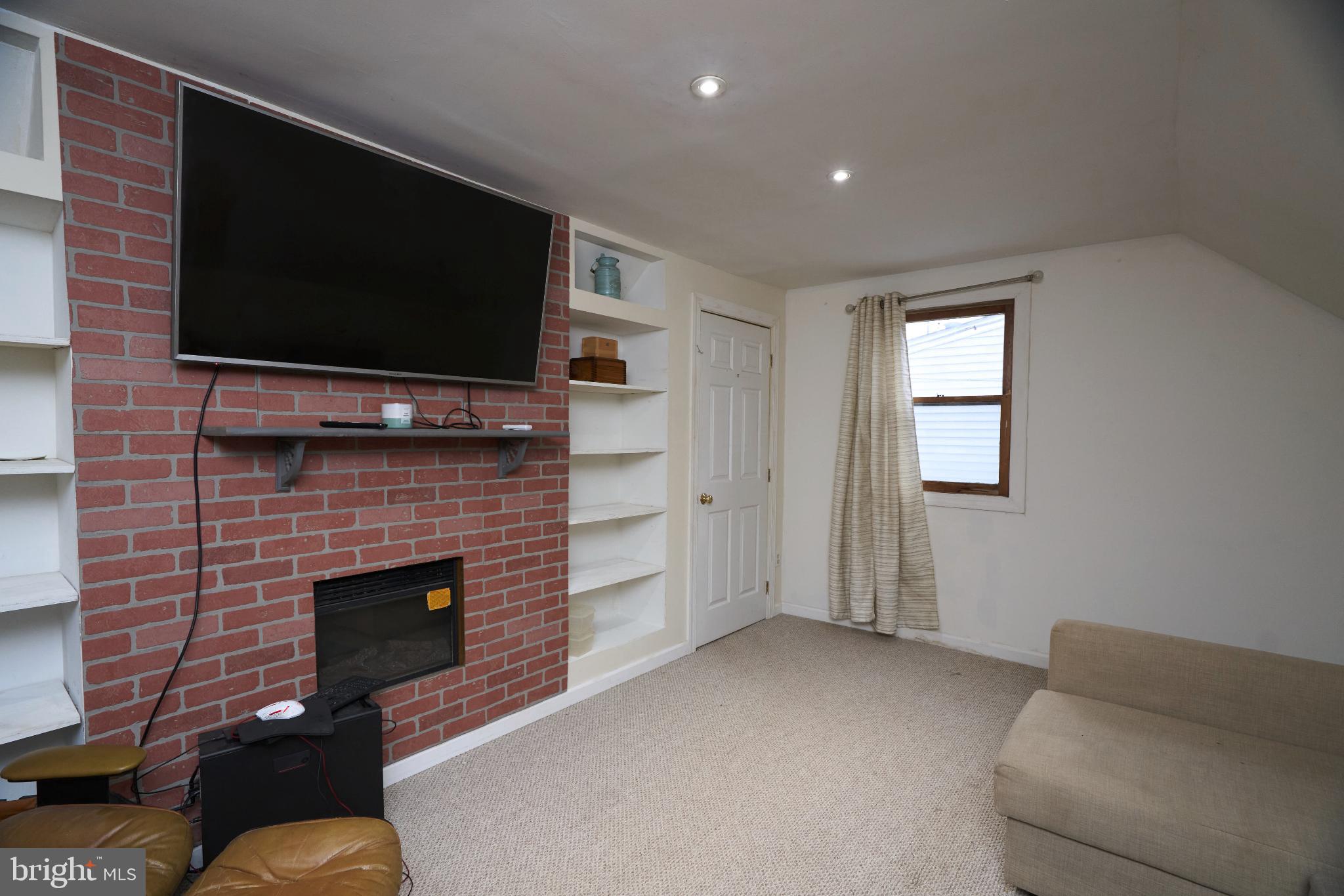 2113 Pennsylvania Avenue Croydon, PA 19021 - Photo 24 of 36 a living room with furniture a flat screen tv and a fireplace
