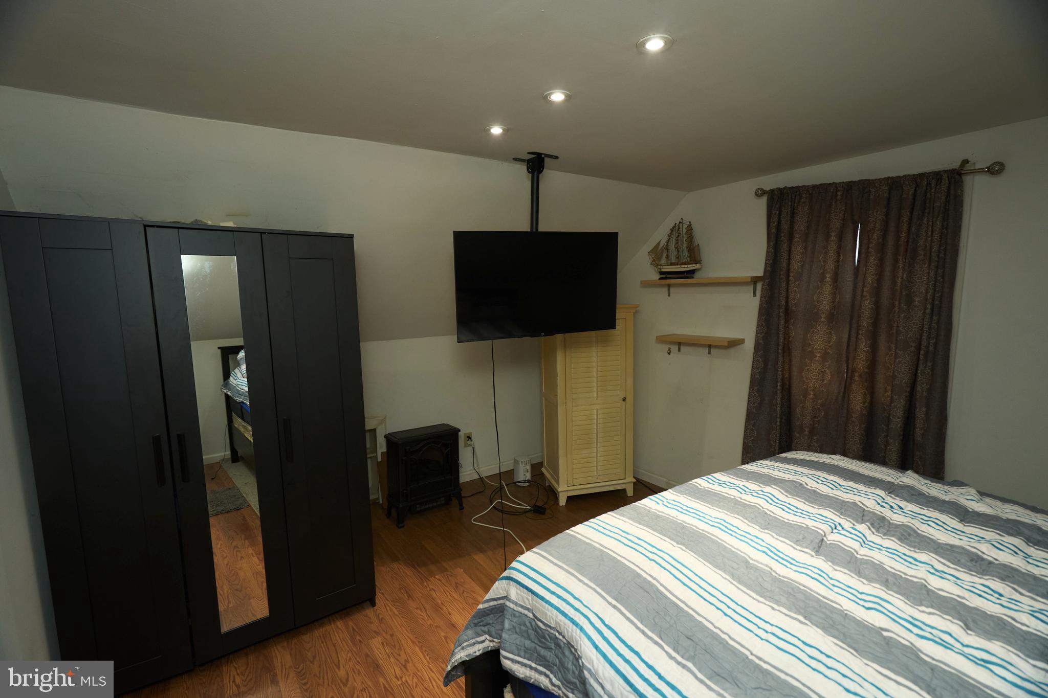 2113 Pennsylvania Avenue Croydon, PA 19021 - Photo 25 of 36 a bedroom with a bed and a flat tv screen