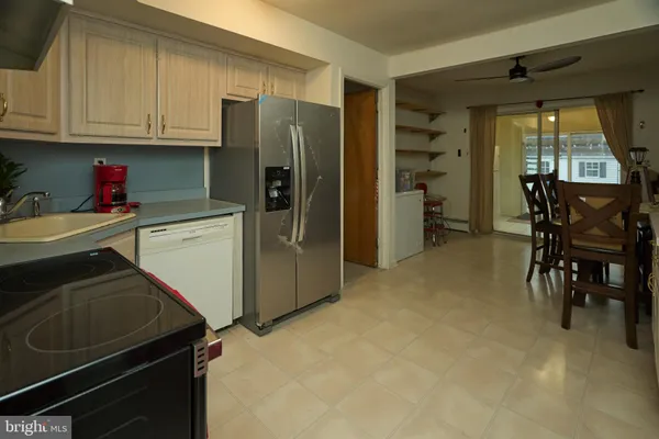 a kitchen with a refrigerator and a stove top oven