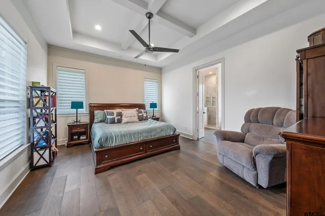 a bedroom with a bed couch and a window