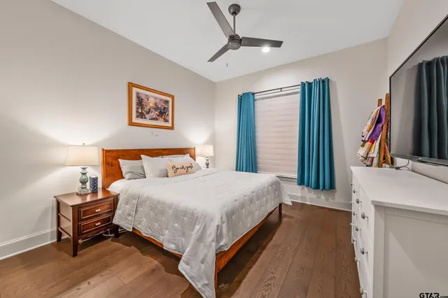 a spacious bedroom with a bed and a flat screen tv