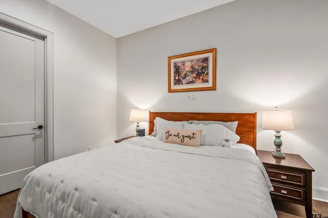 a bedroom with a bed and a night stand